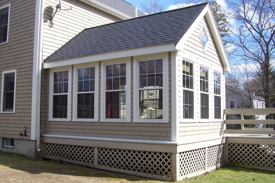 Covered 3-season porch interior with seating area and large windows
